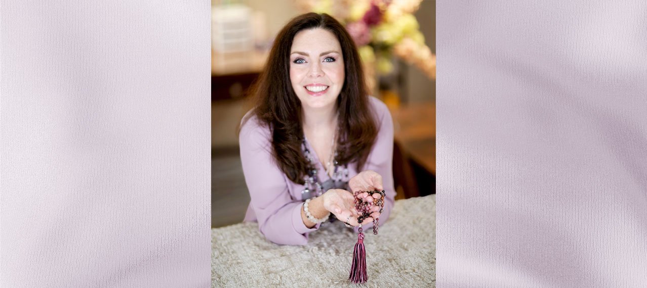Jennifer holding a mala