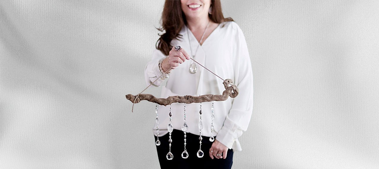 Jennifer holding driftwood mala with crystals