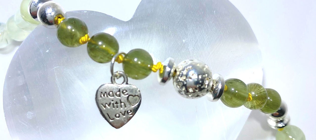 crystals with a silver heart marked "made with love"